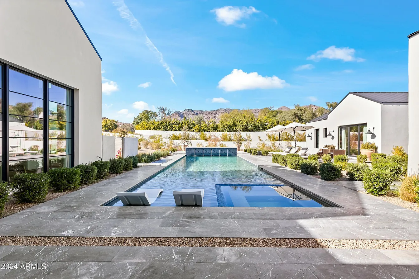 A modern white house with mountain background