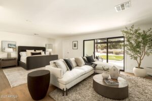 A room with bed, side table and a couch set.