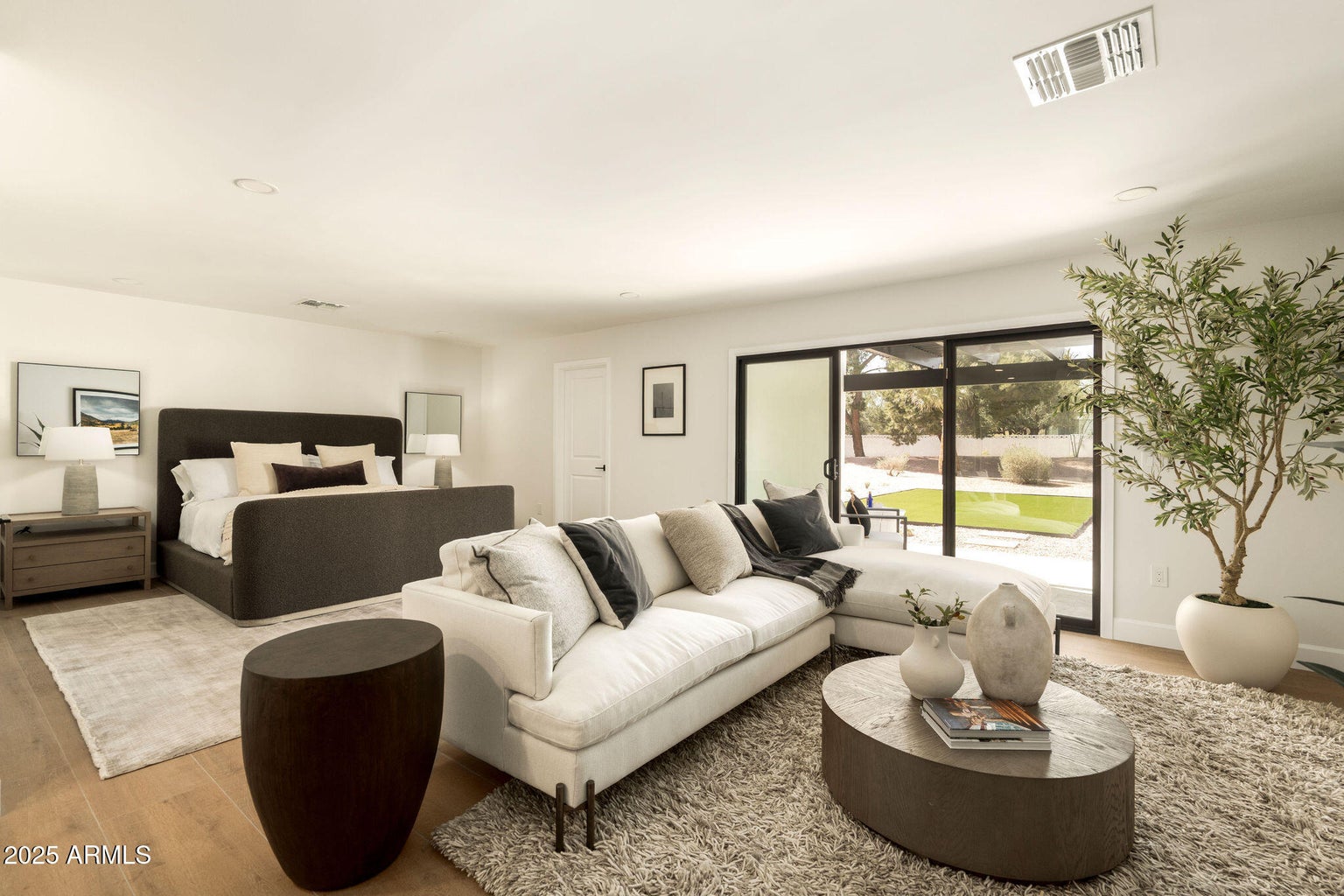 A room with bed, side table and a couch set.