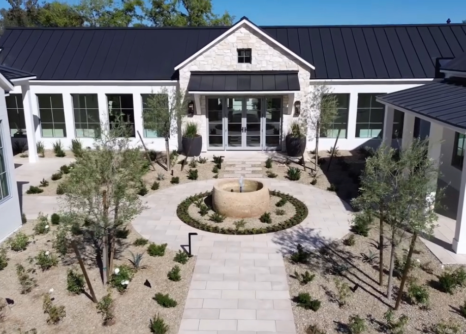 Belmont- Modern house with a circular fountain in the middle of the garden area