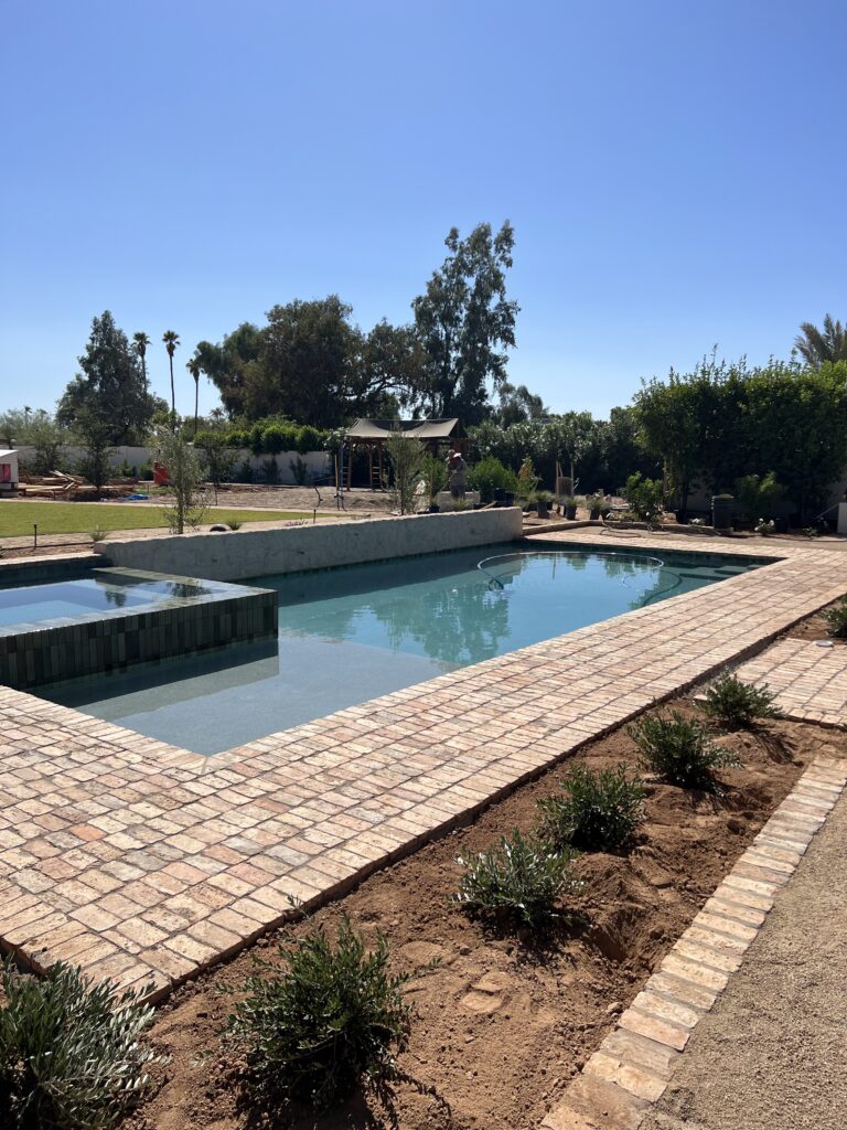 Outdoor view of a desert landscape and a pool