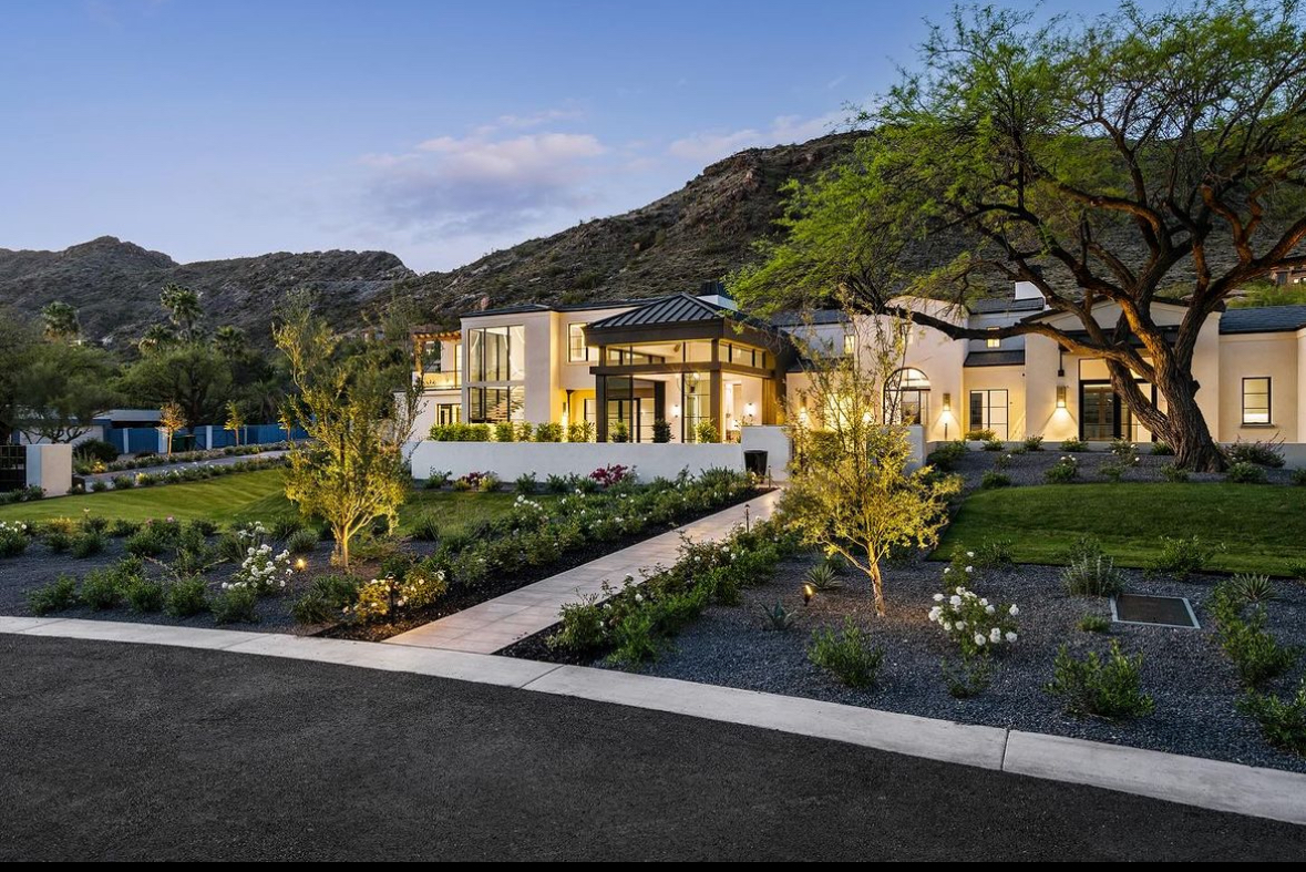 A modern house with lush landscape and mountain views