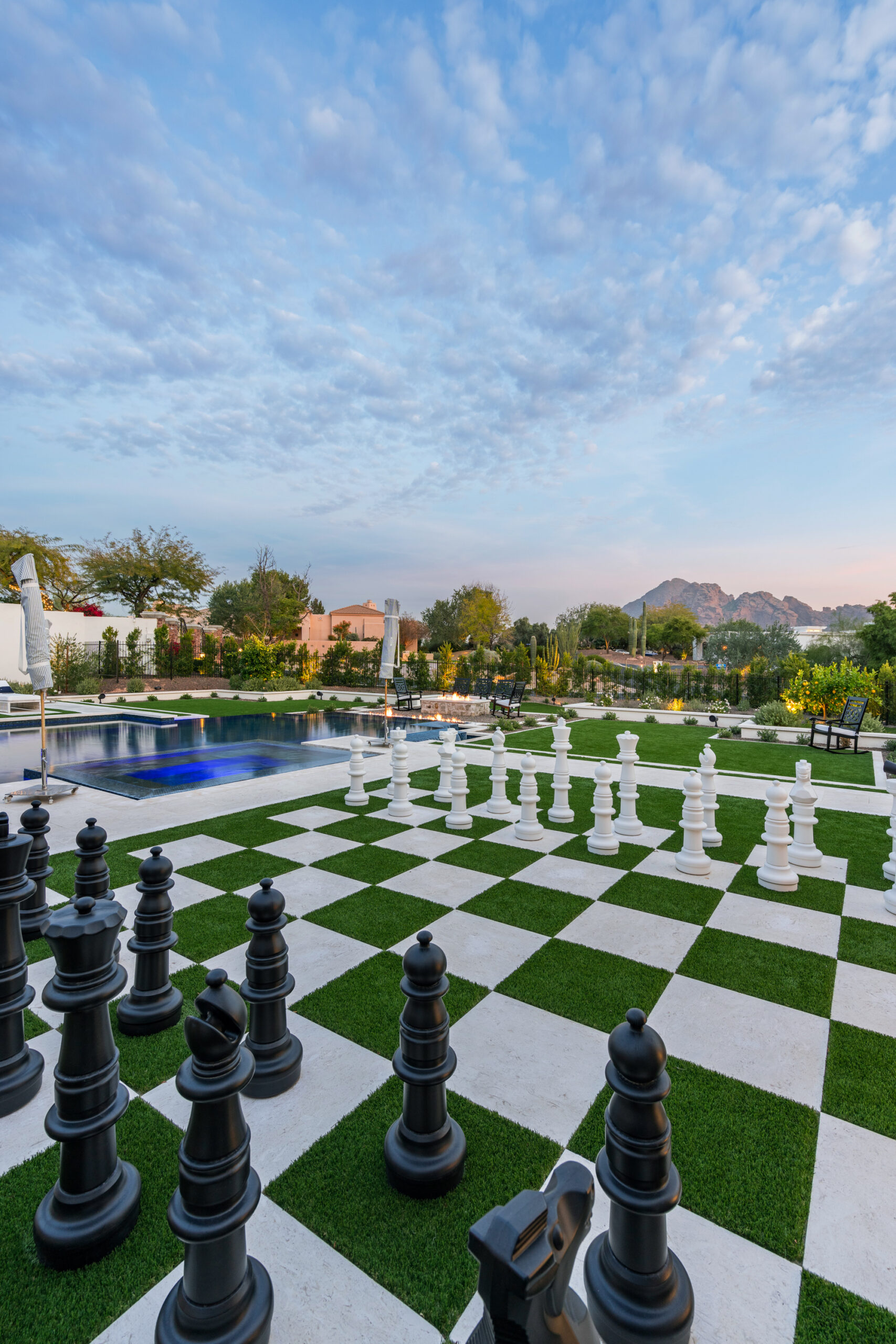 Outdoor giant chess set by a pool with mountain view Innovative pools- 24th street